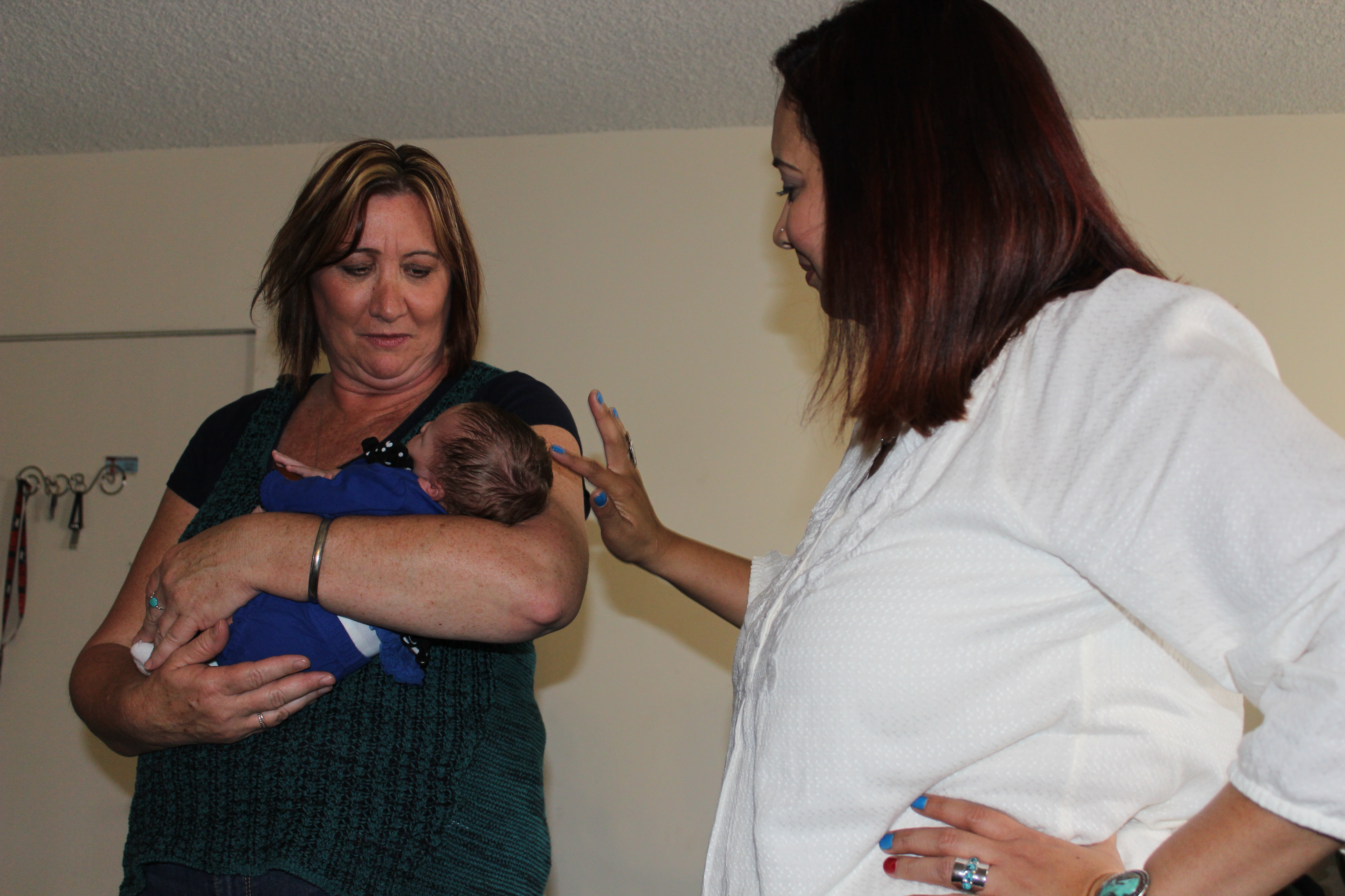 Crittenton Wraparound Staff Michele Fischer and Roxanne Mata holding Baby Beya Treece.